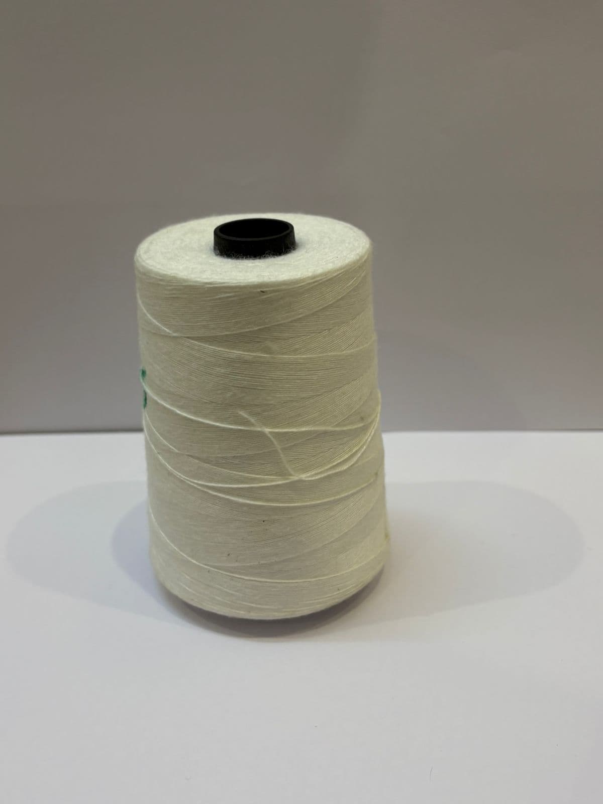 Cream 3-ply recycled polyester yarn spool, 15 count